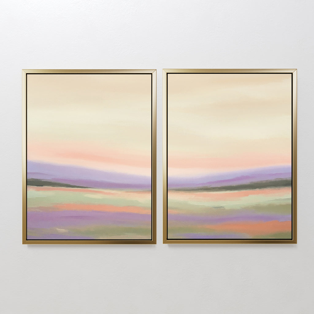 The "Lavender Valley - Set Of 2" features framed abstract landscape paintings with soft pastel shades of pink, purple, green, and beige, depicting rolling hills under a calm sky—perfect serene wall art for any white wall.