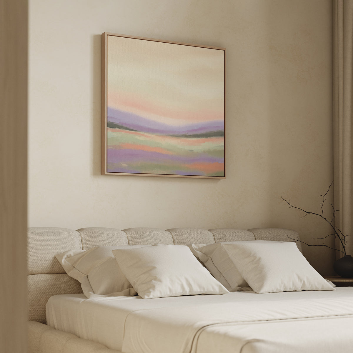 A beige bedroom with a tufted headboard, white bedding, and three pillows features the Lavender Valley Canvas Art - Square above the bed, adding a serene touch that complements the soft natural light and minimalist branch decor.