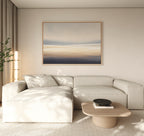 A modern living room with a light beige sectional sofa, wooden coffee table with a black bowl, neutral walls, sheer curtains, a tall plant in the corner, and calming "Layered Dusk Canvas Art - Horizontal" abstract wall art.
