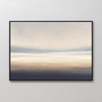 The Layered Dusk Canvas Art - Horizontal is a framed abstract print with soft cream, beige, blue, and gray tones that evoke a misty sunrise—perfect wall art for adding tranquility to any space.