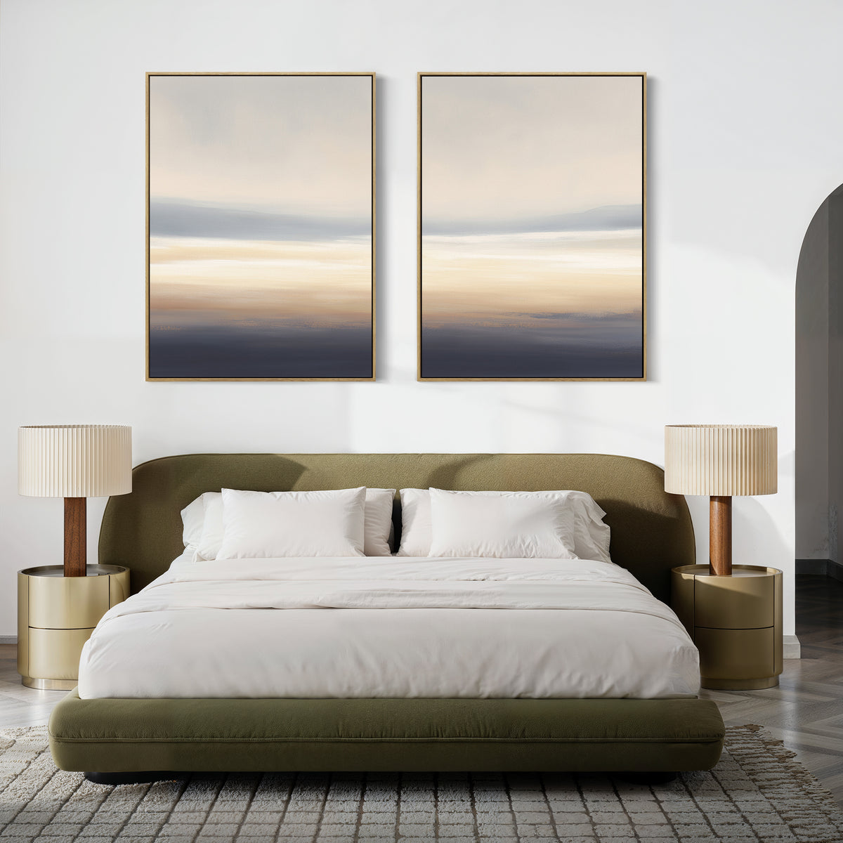 A modern bedroom with a green upholstered bed, white bedding, two gold nightstands with beige lamps, a light patterned rug, and Layered Dusk - Set Of 2 abstract wall art hanging above the bed.