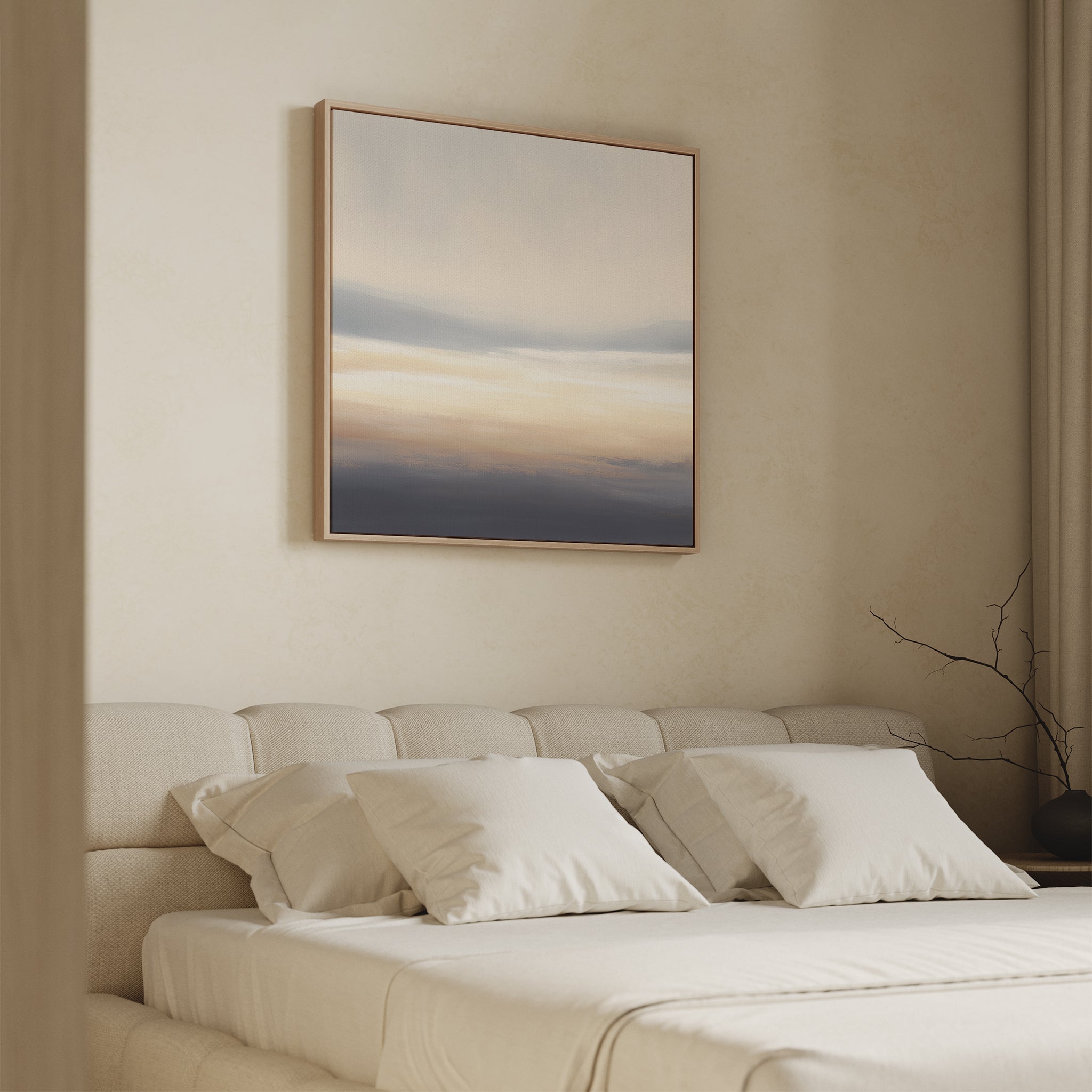 A softly lit bedroom features a beige upholstered bed with white pillows and bedding. Above hangs the Layered Dusk Canvas Art - Square, its neutral abstract tones adding Nordic Park tranquility beside floor-length curtains and a bare branch.