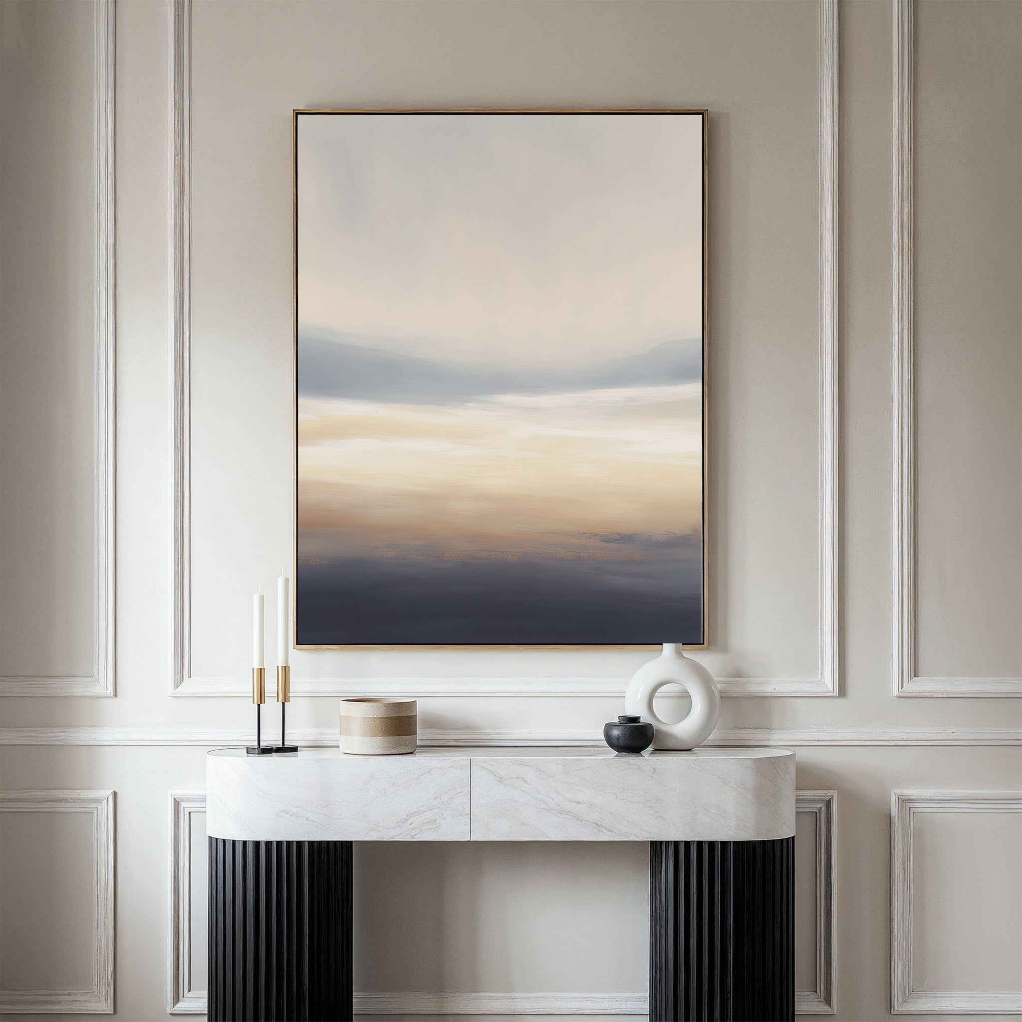 A minimalist hallway showcases a marble console table with black legs, candles, a round vase, and a lidded container. Above the paneled wall hangs the Layered Dusk Canvas Art - Vertical as striking abstract wall art.