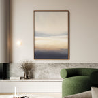 A modern living room features the Layered Dusk Canvas Art - Vertical as wall art, a round green sofa, stone bench, dried branch vase, and minimal decor in a neutral-toned setting.