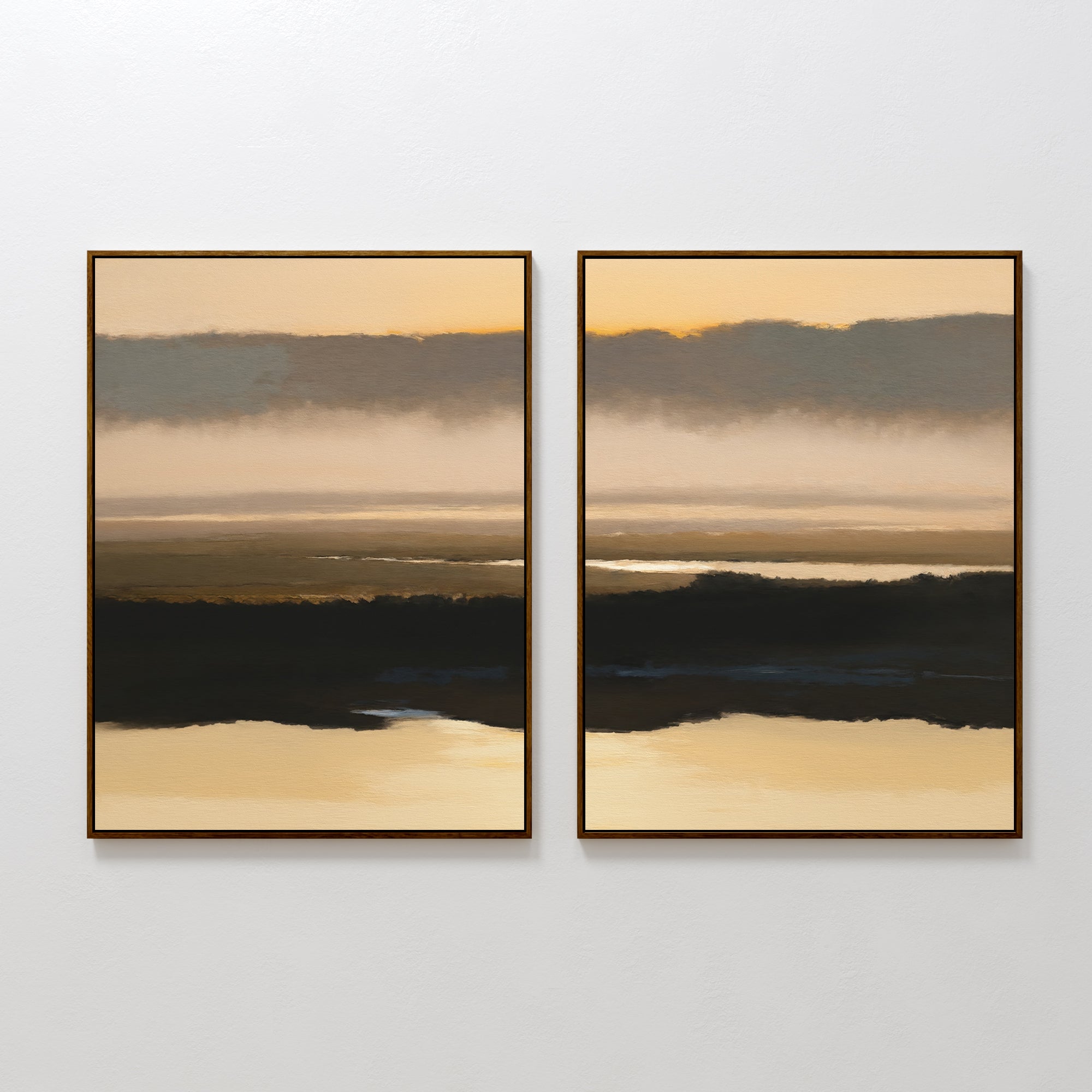 The "Layered Valley Dawn - Set Of 2" features framed abstract landscapes in soft brown, beige, and gold hues, depicting tranquil water, dark land, and a cloudy sky at sunrise or sunset on a white wall.