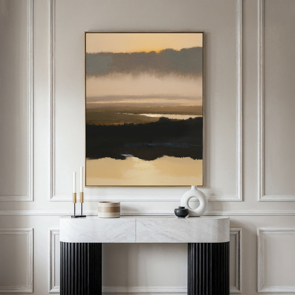A minimalist console table with decor sits against a light wall, topped by the Layered Valley Dawn Canvas Art - Vertical, a serene abstract landscape in beige, black, and brown tones.