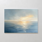 The Luminous Calm Canvas Art - Horizontal depicts a tranquil sea beneath a cloudy sky, with soft sunlight on the water. Its blend of cool blues and warm golds creates a peaceful, serene atmosphere for any space.