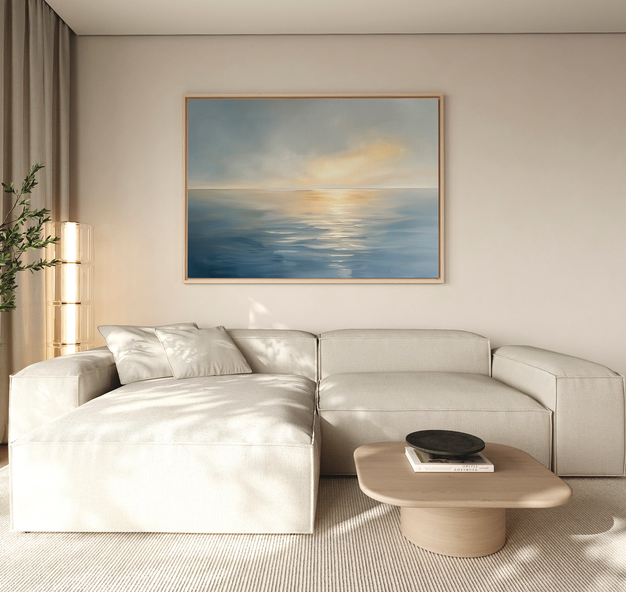 A modern living room with a beige sectional, light wood coffee table, tall lamp, potted plant, and the Luminous Calm Canvas Art - Horizontal in coastal blue and yellow tones creates a tranquil atmosphere on the wall.