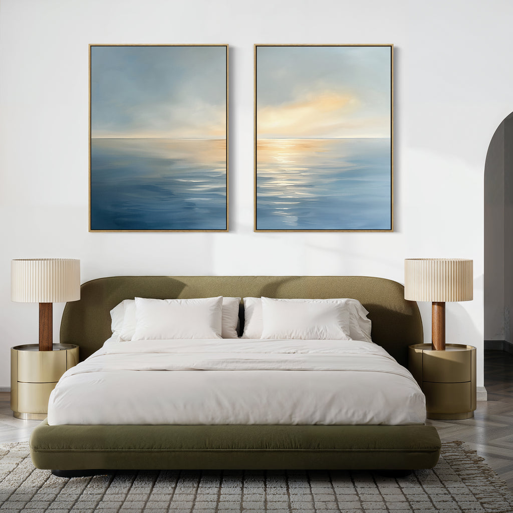 A modern bedroom with an olive-green bed, white bedding, and beige nightstands topped with matching lamps features a calm vibe, enhanced by the Luminous Calm - Set of 2 abstract ocean-themed canvases above the bed for a serene coastal touch.
