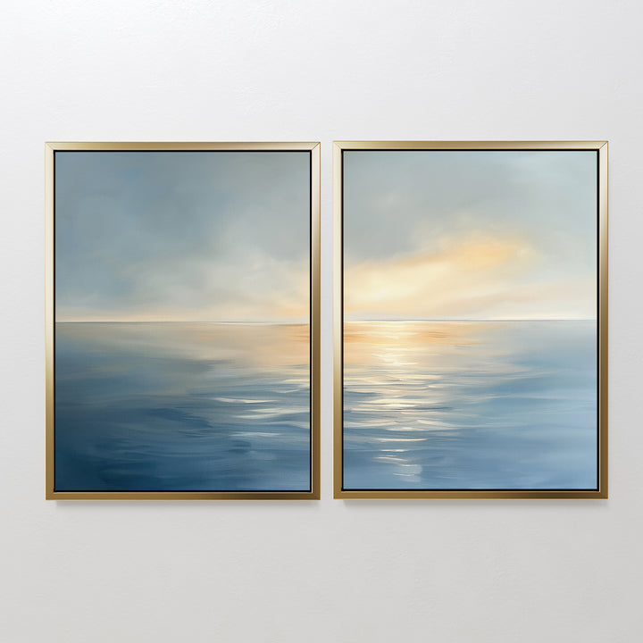 Luminous Calm - Set of 2: Two framed canvas prints feature a serene ocean in soft coastal hues, with hazy skies and golden light. Their minimal design brings a tranquil atmosphere when displayed together on a white wall.