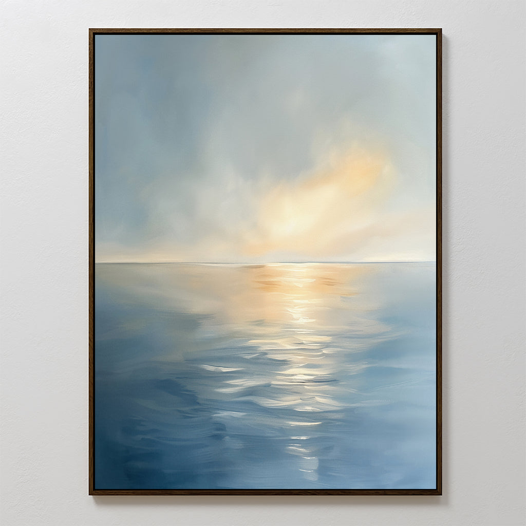 The Luminous Calm Canvas Art - Vertical features a tranquil sea with gentle ripples, reflecting soft sunlight through clouds in soothing blue, gray, and warm yellow hues—perfect for adding a serene coastal touch to any space.