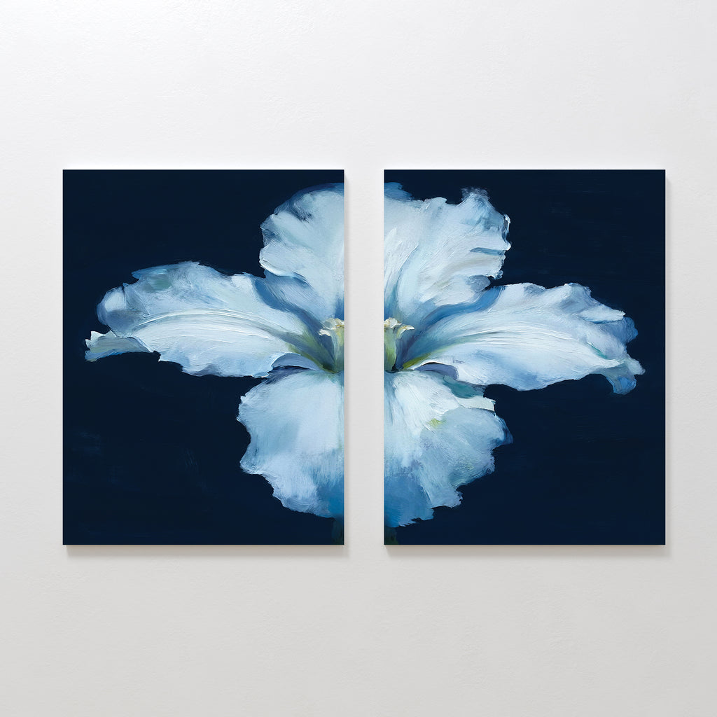 Luminous Iris - Set of 2: A diptych painting featuring a large, radiant iris with delicate petals split across two canvases, set against a dark navy blue background and displayed on a light-colored wall.