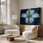 A modern living room featuring two white rounded chairs, a low wooden coffee table, a tall floor lamp, and the Luminous Iris - Set of 2 canvas prints on a sideboard by a bright window.