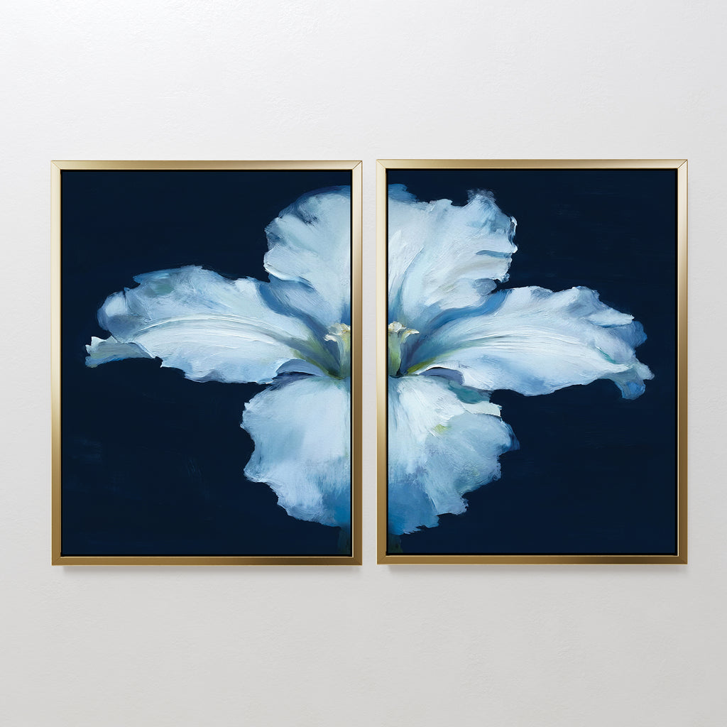 The "Luminous Iris - Set of 2" features diptych wall art with soft blue iris petals on a dark blue backdrop, split across two gold-framed canvases to create a serene Nordic vibe, perfect for display on a white wall.