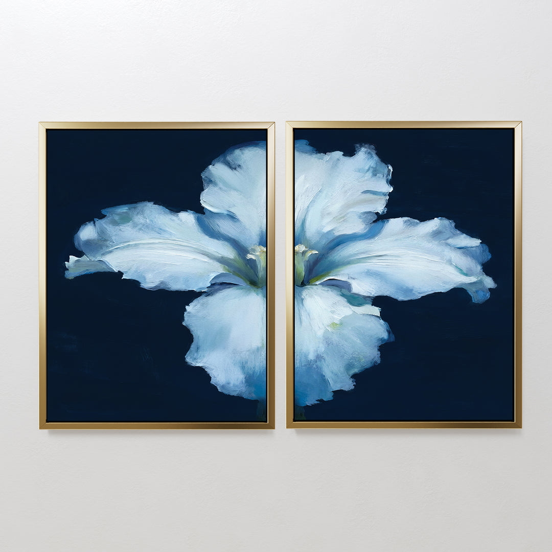 The "Luminous Iris - Set of 2" features diptych wall art with soft blue iris petals on a dark blue backdrop, split across two gold-framed canvases to create a serene Nordic vibe, perfect for display on a white wall.