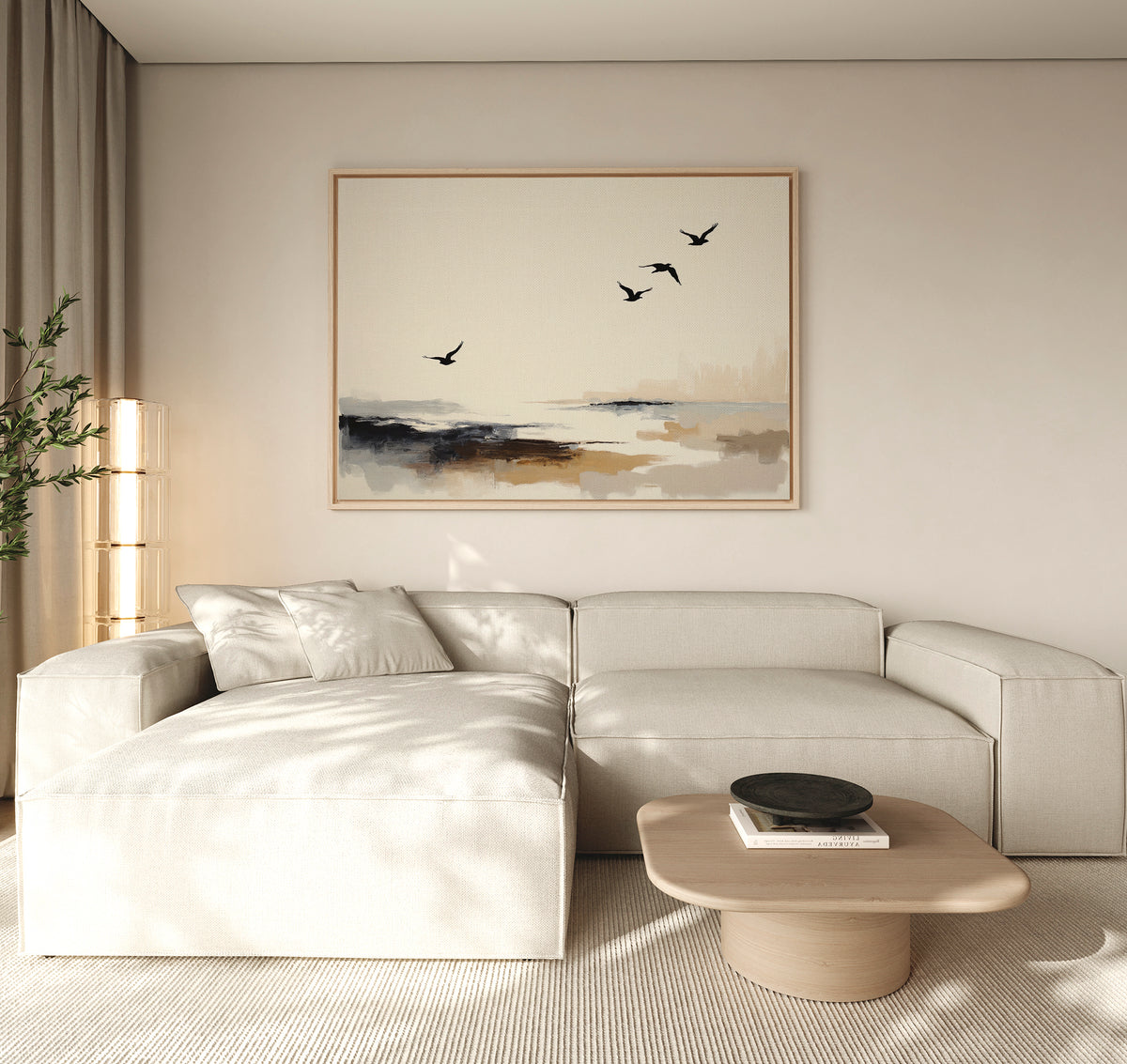 A modern, minimalist living room features a light beige sectional sofa, a low wooden coffee table with a black bowl, and the Maritime Flight Canvas Art - Horizontal depicting birds over an abstract landscape. Neutral tones and soft lighting add warmth.