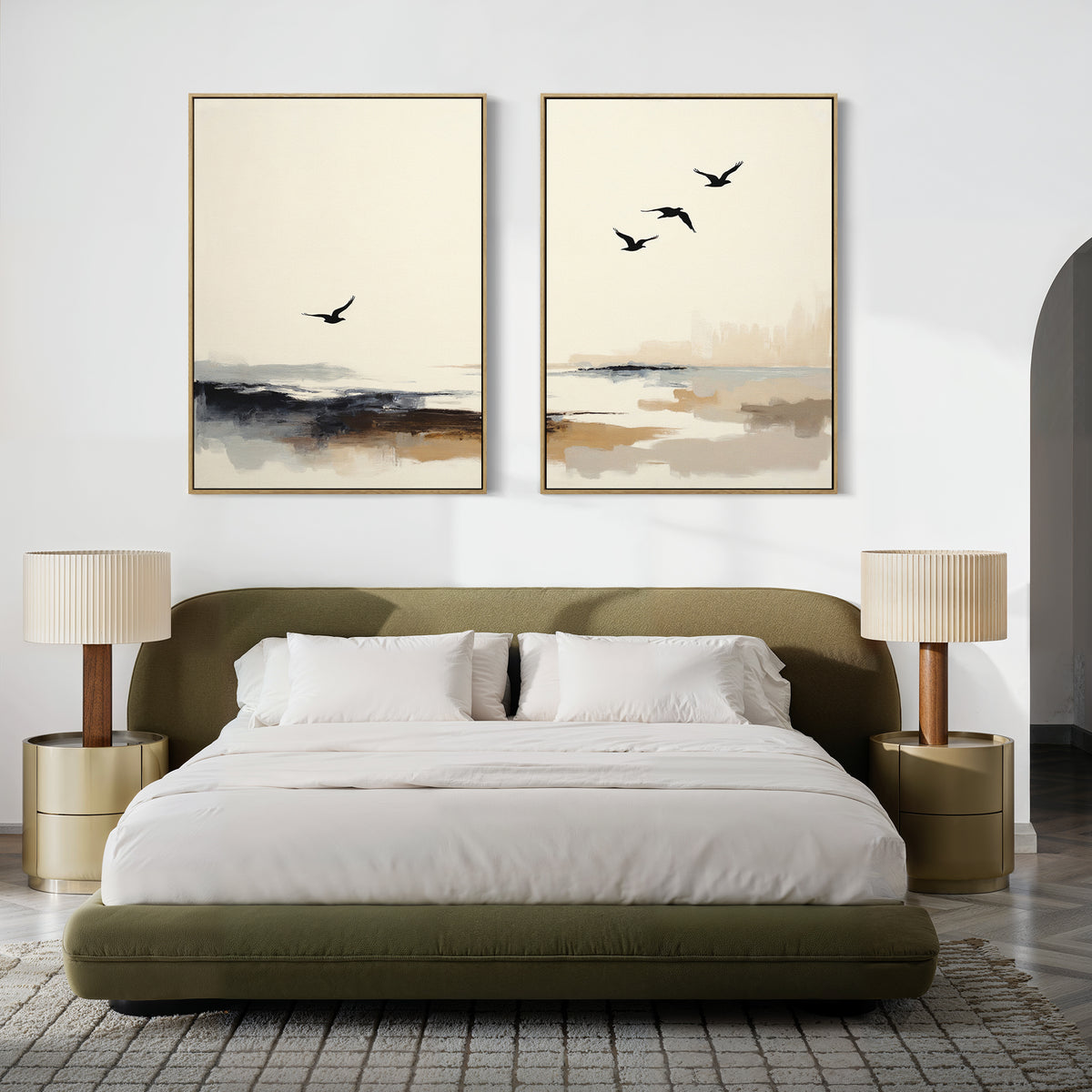 A modern bedroom with a green upholstered bed, white bedding, two gold bedside tables with beige lamps, and the Maritime Flight - Set Of 2 prints featuring abstract birds and landscapes above the bed.