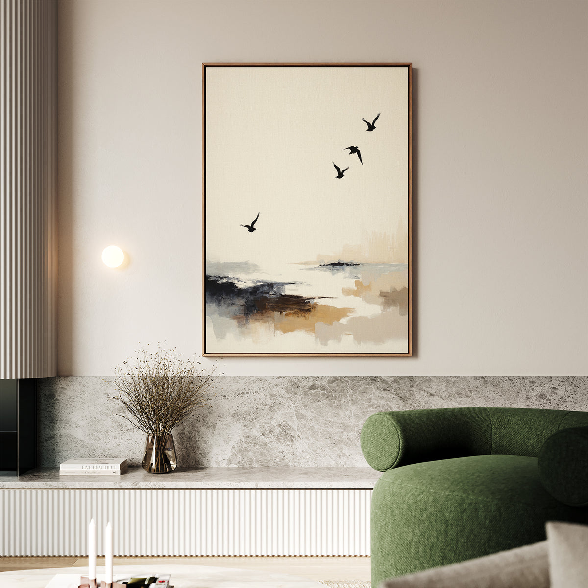 A modern living room with a green sofa and coastal decor showcases a built-in bench with marble detail. Above, the Maritime Flight Canvas Art - Vertical hangs, depicting an abstract seascape with four birds in flight. A vase with dried branches sits nearby.