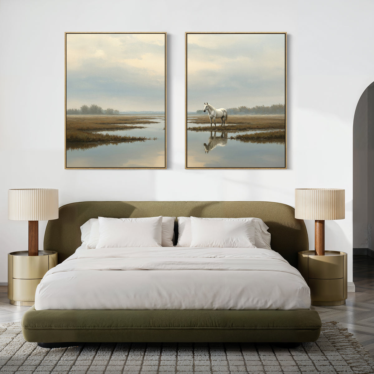 A modern bedroom with an olive green bed, white bedding, two beige nightstands with matching lamps, and the Marsh Reflection - Set Of 2 landscape prints above the bed, including a serene image featuring a white horse by water.