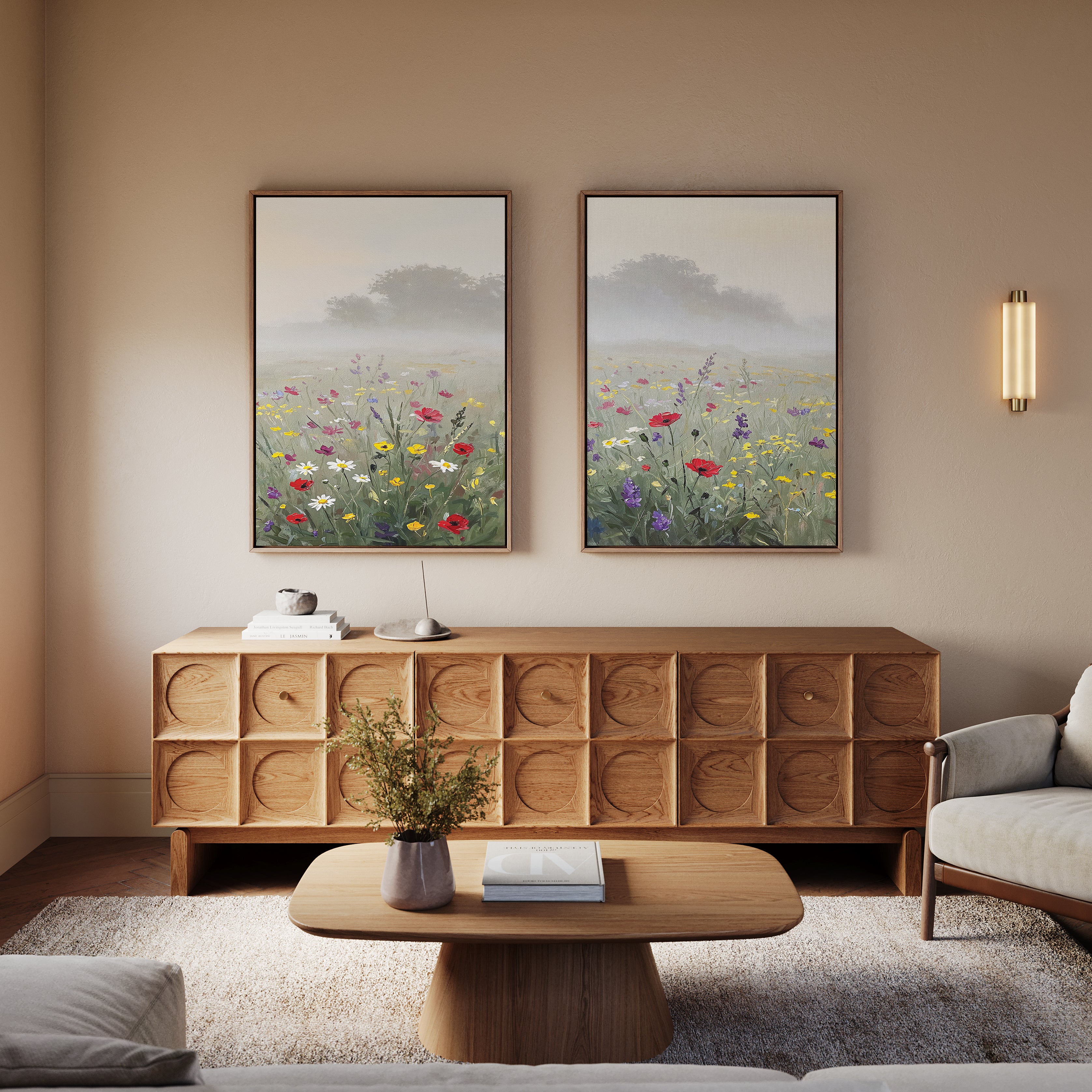A cozy living room with a wooden cabinet, a low coffee table, a light sofa, and two Meadow Dreams - Set of 2 wall art pieces featuring wildflowers and trees above the cabinet. A small vase with flowers sits on the table.