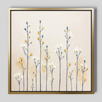 The Meadow Symphony Canvas Art - Square features tall, thin flower stems with white and yellow blossoms on a light beige backdrop in a gold frame. This minimalist wildflowers wall art adds a soft, modern botanical touch—ideal spring meadow decor for any space.