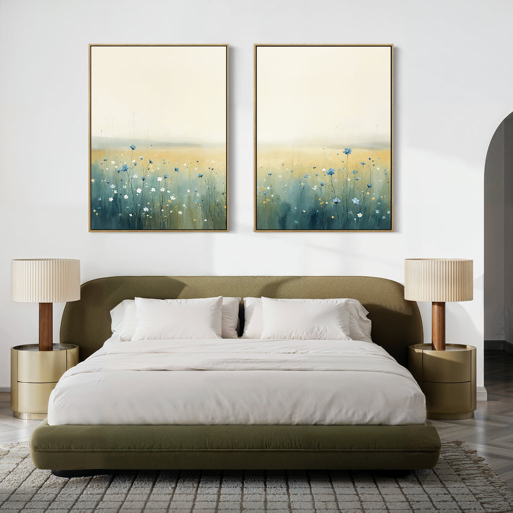 A modern bedroom features an olive-green bed, white bedding, beige nightstands with matching lamps, and "Meadow Whispers - Set of 2" wildflower wall art above the headboard for a serene, stylish atmosphere.