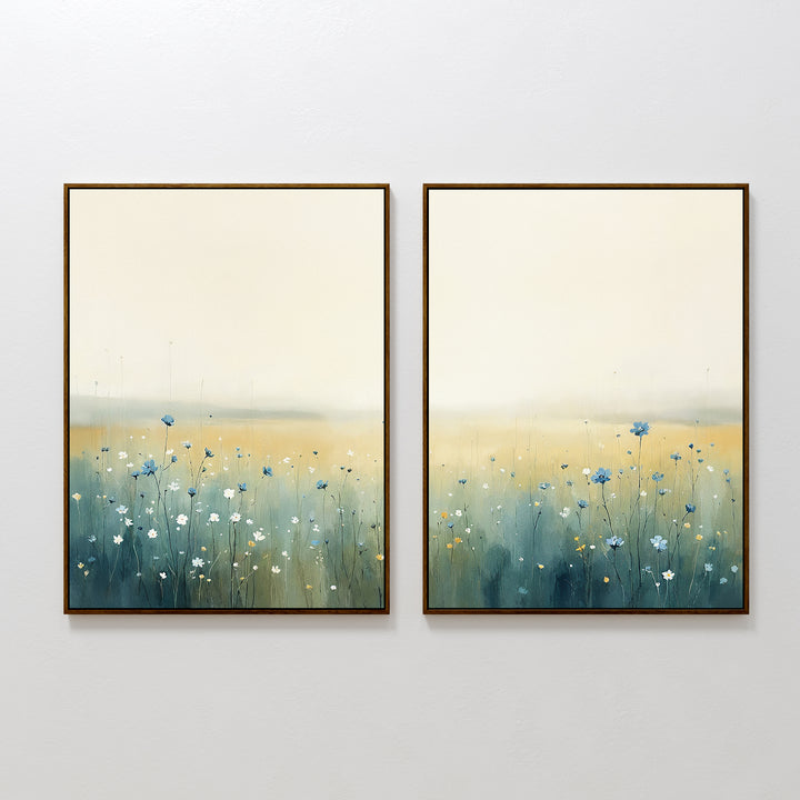 Meadow Whispers - Set of 2: Framed canvas prints featuring impressionistic wildflower fields in soft blue and white beneath hazy yellow and cream skies, displayed side by side on a white wall.