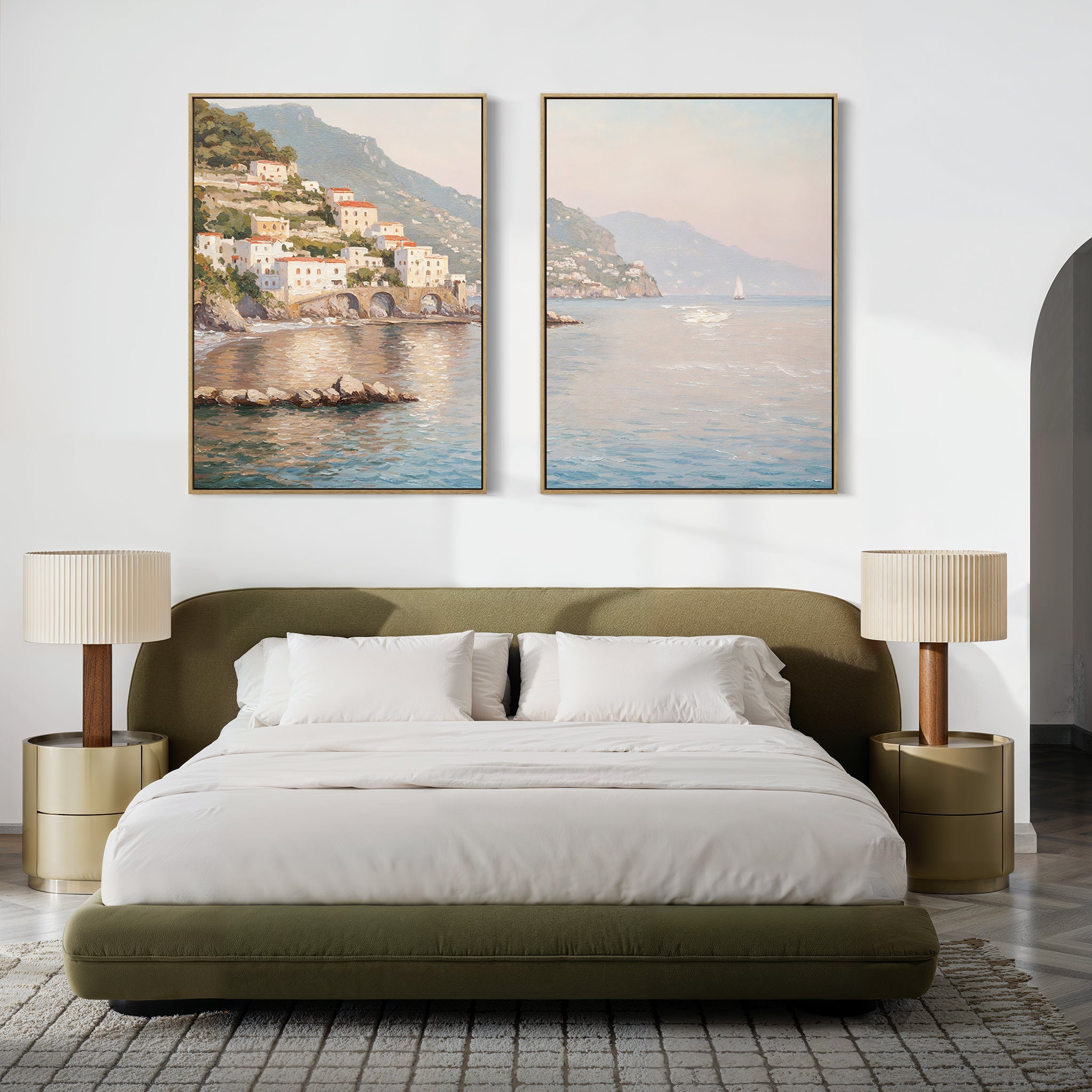 A modern bedroom with a green upholstered bed, neutral bedding, gold nightstands with beige lamps, and serene decor featuring the "Mediterranean Dreams - Set of 2" coastal village wall art above the bed.
