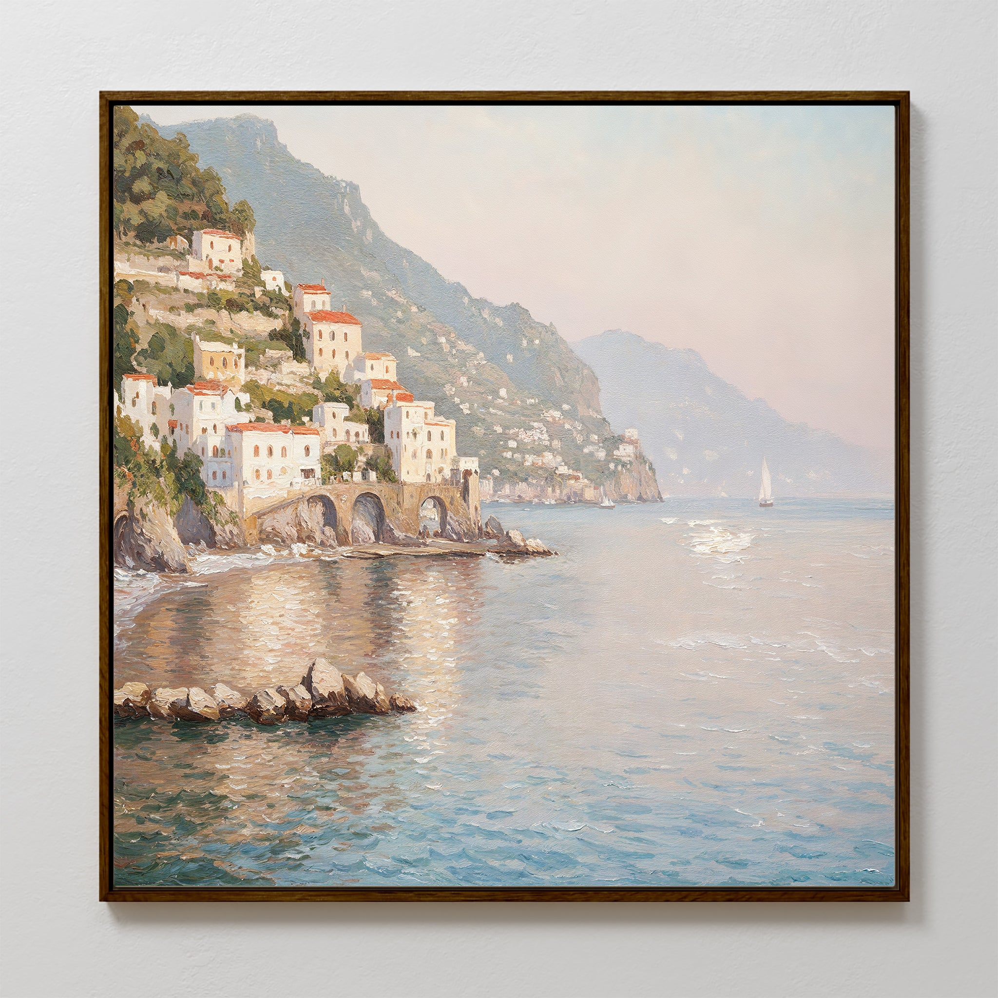 The Mediterranean Dreams Canvas Art - Square features a coastal village with white buildings and red roofs by a sunlit sea, distant mountains, and a passing sailboat—perfect Mediterranean wall art to add serene home decor.
