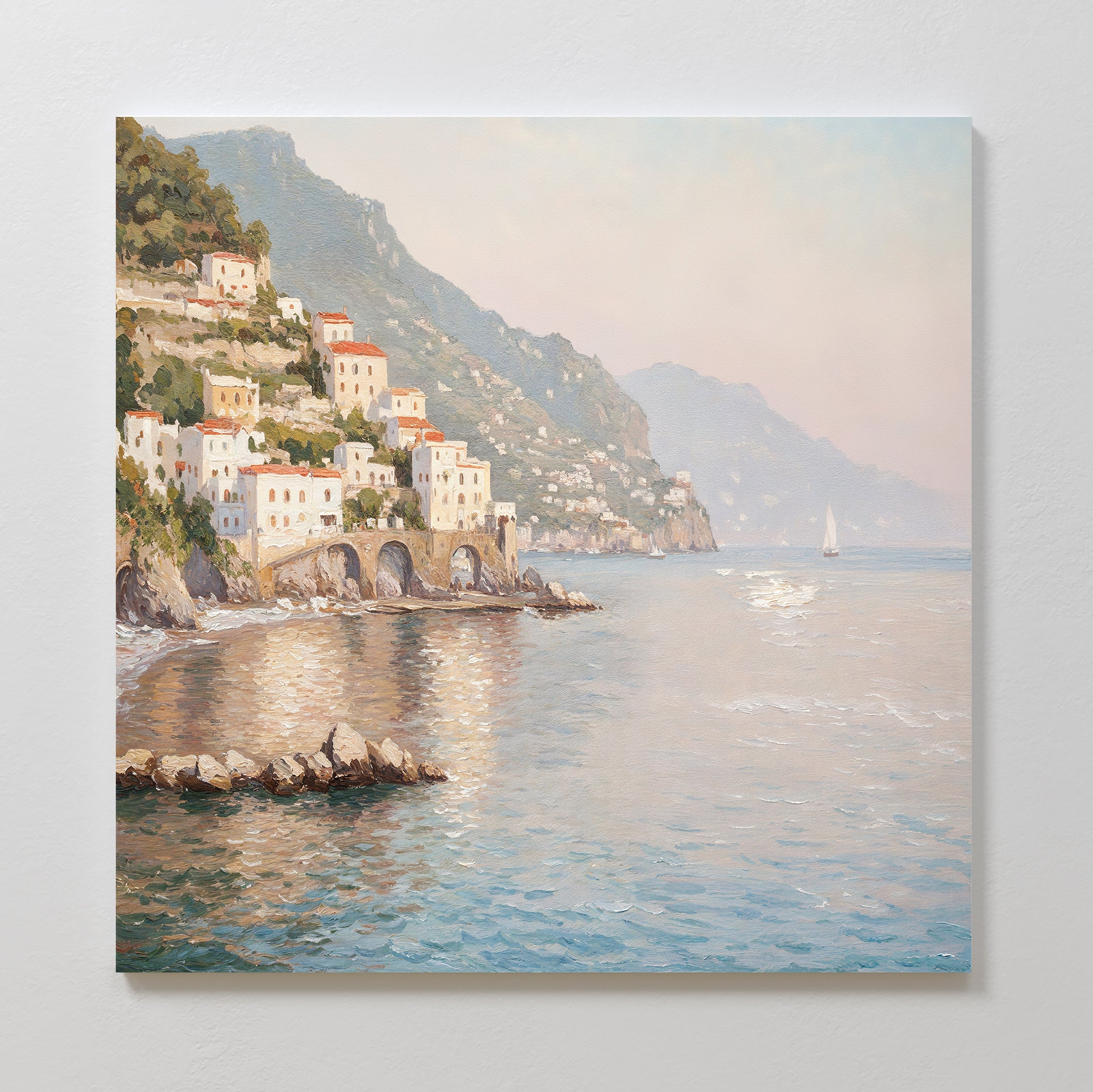 The Mediterranean Dreams Canvas Art - Square depicts white and orange-roofed cliffside houses overlooking a tranquil blue sea with mountains and a sailboat—ideal for adding serene coastal charm to your home decor.