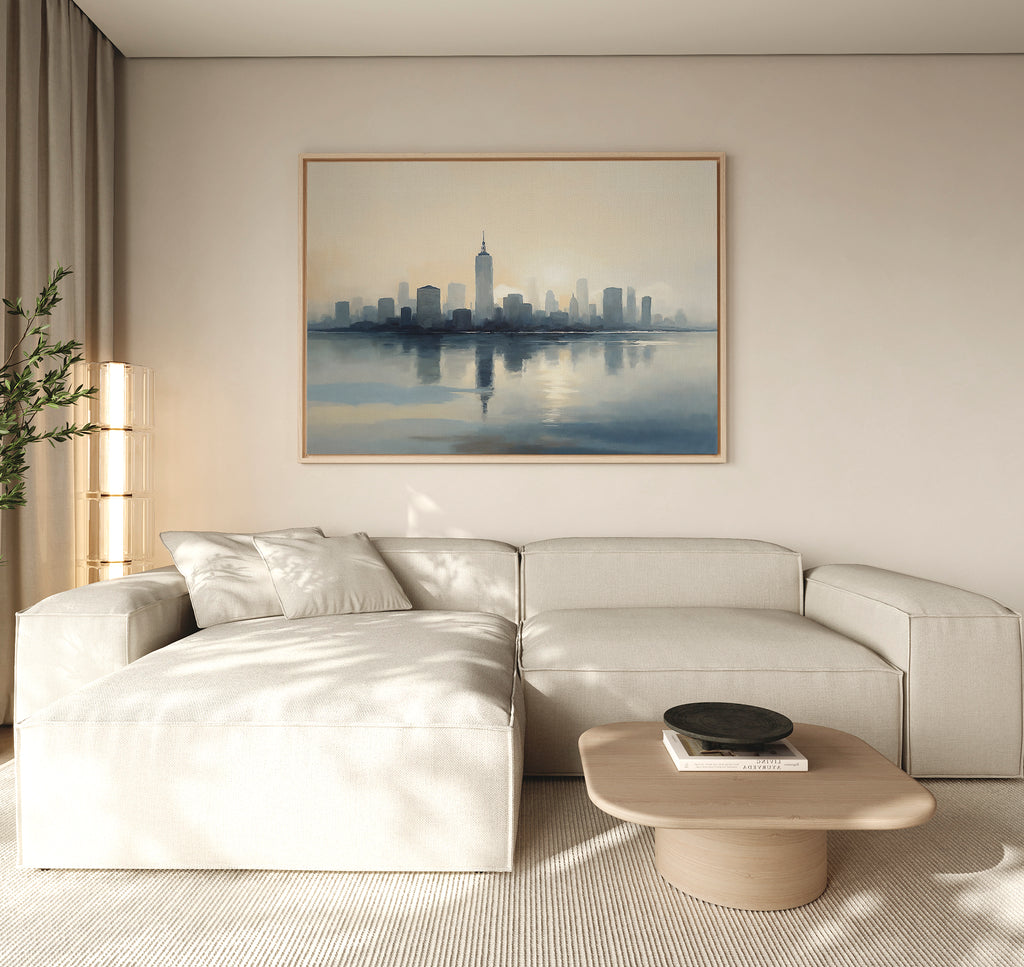 A modern living room with a white sectional sofa, light wood coffee table, potted plant, floor lamp, and the Metropolitan Dawn Canvas Art - Horizontal adding urban tranquility above the sofa.