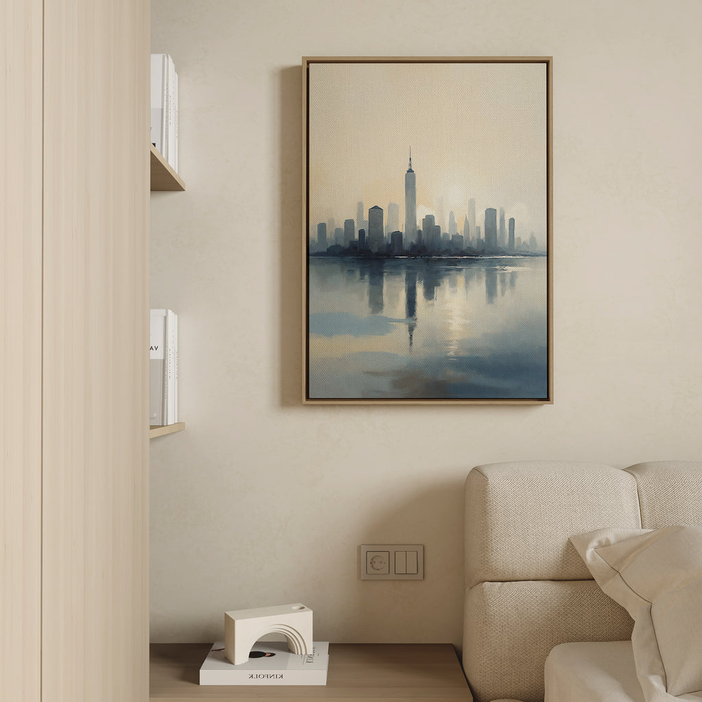 A modern living room with a beige sofa, built-in bookshelf, and the Metropolitan Dawn Canvas Art - Vertical—a city skyline reflected in water—mounted on a light-colored wall.
