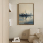 A modern living room with a beige sofa, built-in bookshelf, and the Metropolitan Dawn Canvas Art - Vertical—a city skyline reflected in water—mounted on a light-colored wall.