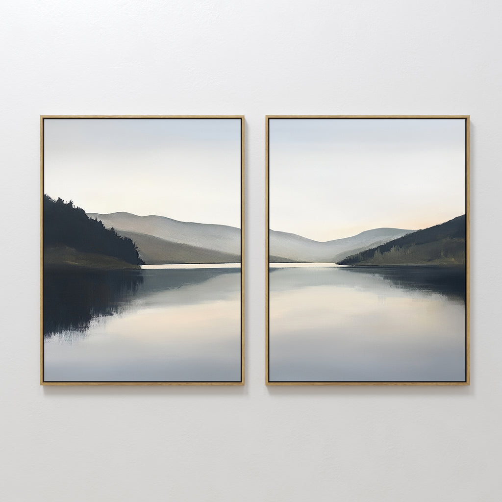 The "Mirror Valley - Set of 2" features framed canvas prints showcasing a tranquil lake, distant hills, and a cloudy sky in muted blues, grays, and greens for a serene Nordic Park vibe.