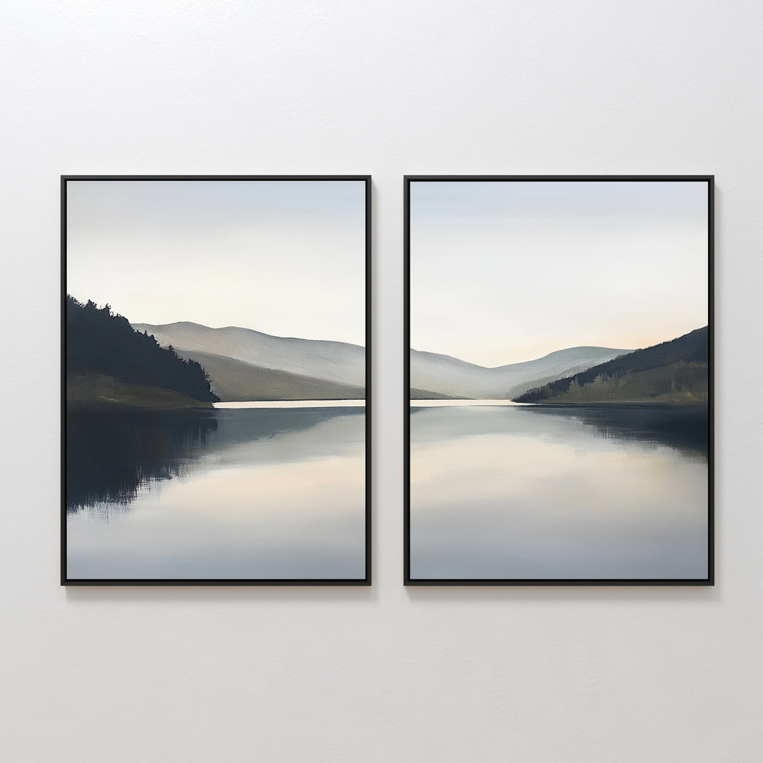 The Mirror Valley - Set of 2 features framed canvas prints showing a serene lake reflecting distant hills and a cloudy sky, with muted blue and gray tones that capture the peaceful essence of a Nordic park.