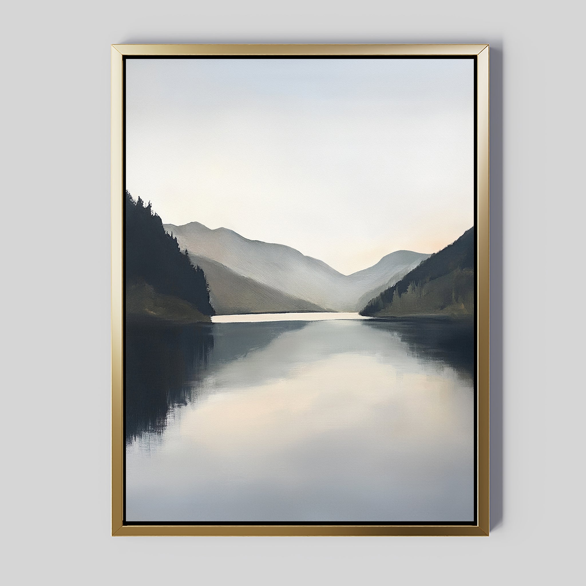 Mirror Valley Canvas Art - Vertical: This framed canvas shows a calm lake mirroring misty mountains beneath an overcast sky. Muted blue and gray tones and soft hills make it perfect for adding Nordic decor vibes to any space.