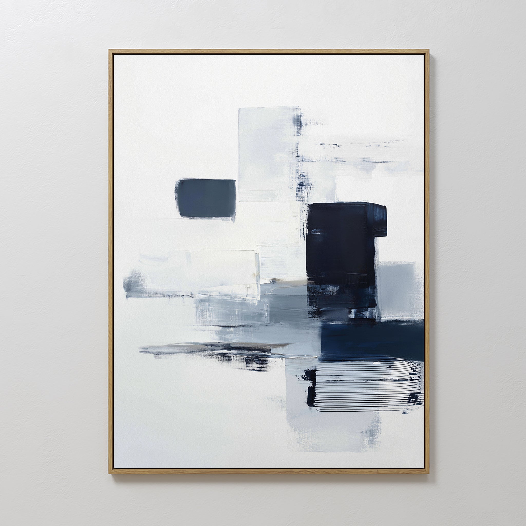 The Navy Brushwork Canvas Art - Vertical features modern geometric rectangular and square shapes in white, gray, and dark blue on a white background, framed with thin gold detailing—perfect for minimalist home decor.