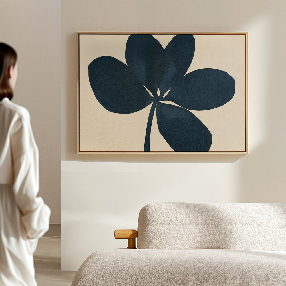 A woman admires the serene beauty of the Navy Clover Canvas Art - Horizontal as it hangs on a minimalist wall, lost in thought.