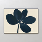 The Navy Clover Canvas Art - Horizontal features a dark blue abstract five-petal flower with a single stem on a light beige background, framed in black for a minimalist touch and designed to elevate any plain white wall.