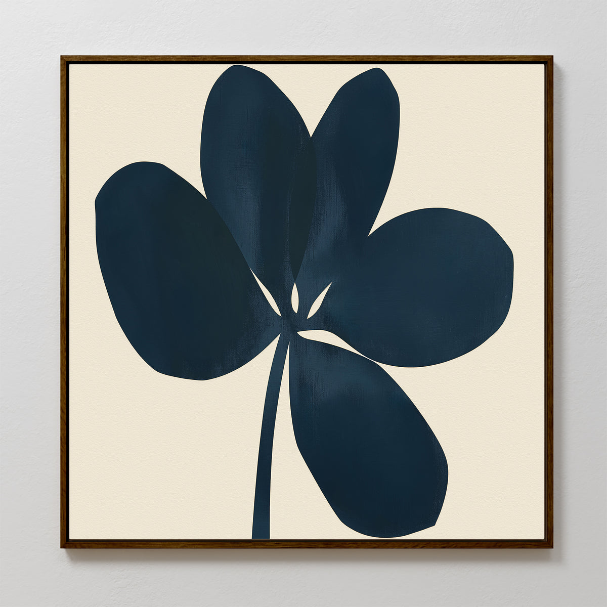 The Navy Clover Canvas Art - Square features a dark blue abstract five-petal flower with a single stem on a light beige background, framed in simple brown wood—ideal for modern botanical or minimalist wall decor.