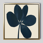 The Navy Clover Canvas Art - Square features a dark navy abstract flower with five petals on a light beige background, framed in a sleek gold-colored frame—ideal minimalist wall decor for a botanical touch.
