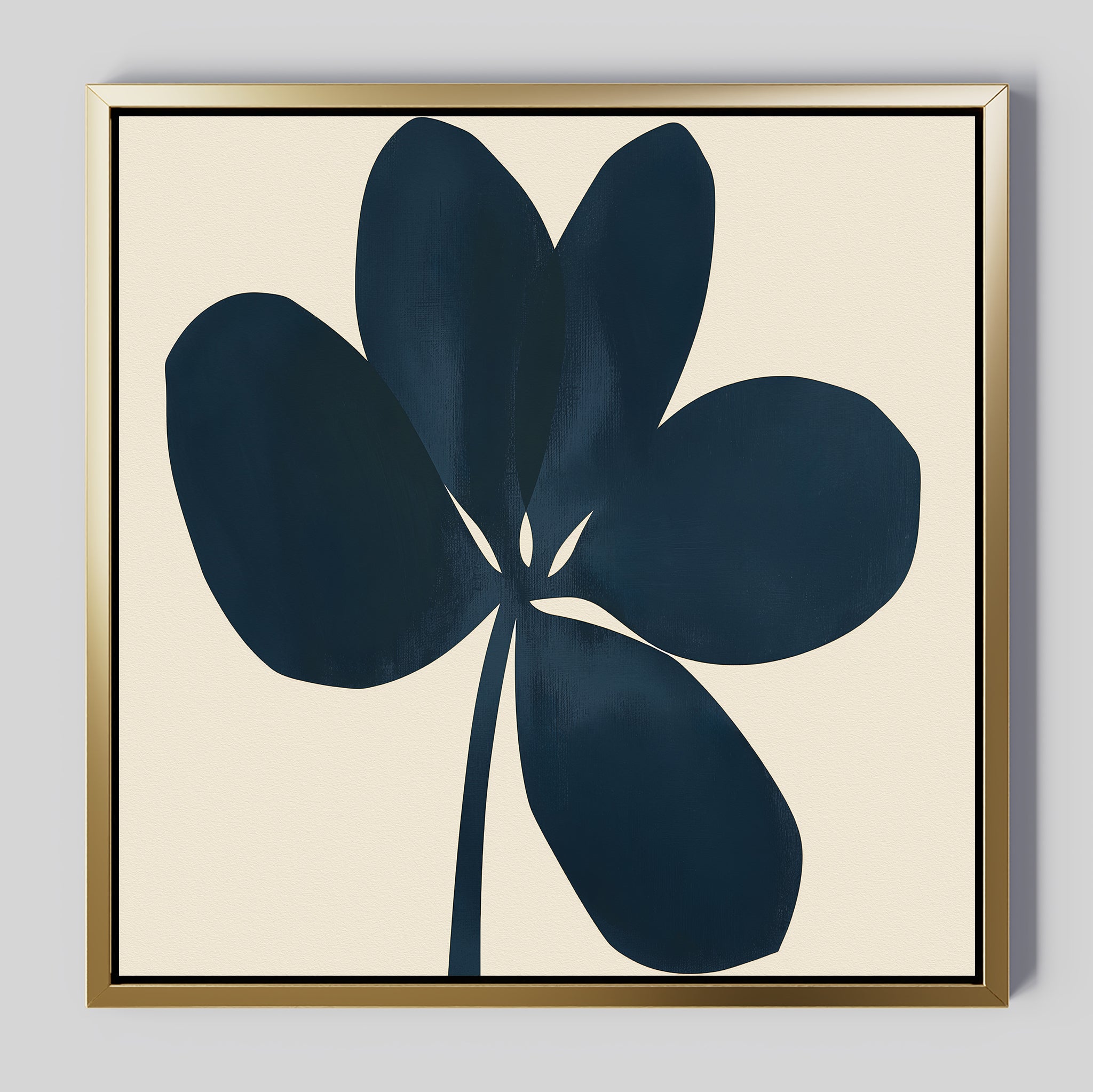 The Navy Clover Canvas Art - Square features a dark navy abstract flower with five petals on a light beige background, framed in a sleek gold-colored frame—ideal minimalist wall decor for a botanical touch.