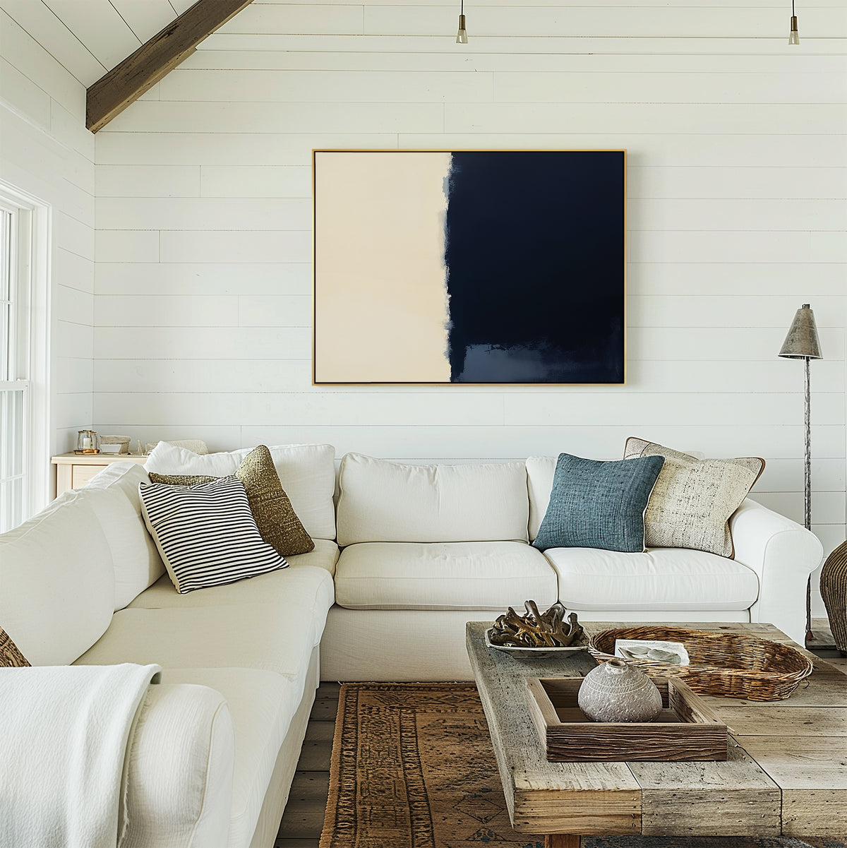 Bright, airy living room with a white sectional sofa, neutral and blue cushions, rustic wooden coffee table, and modern elegance highlighted by the Navy Division Canvas Art - Horizontal on the white shiplap wall.