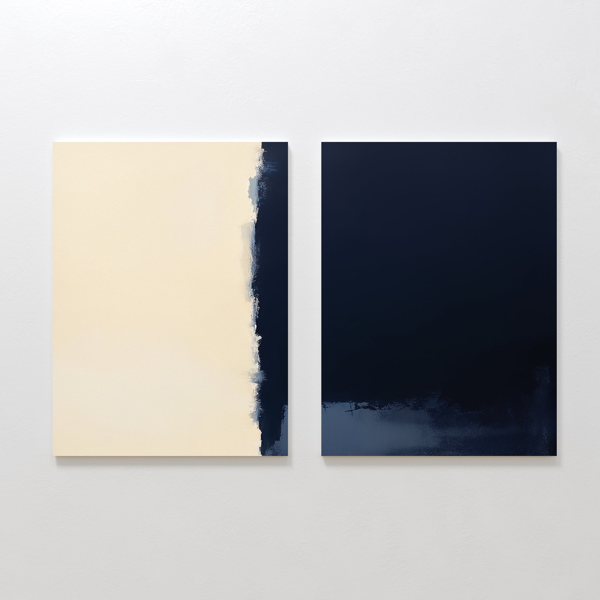 The Navy Division - Set Of 2 features minimalist abstracts: one canvas is mostly cream with a rough navy edge, while the other is a solid navy print with textured dark accents, creating modern elegance side by side on a white wall.