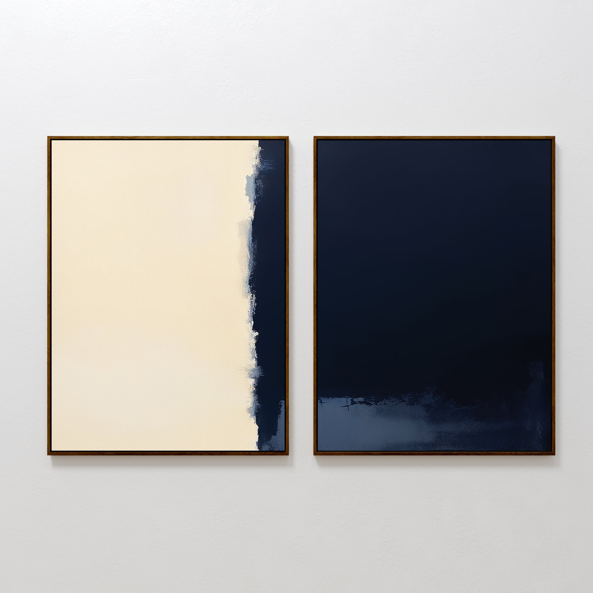 The Navy Division - Set Of 2 features two framed abstract prints: one with off-white and dark blue split by a rough edge, and the other mostly dark blue with subtle bottom texture, both exuding modern elegance on any wall.