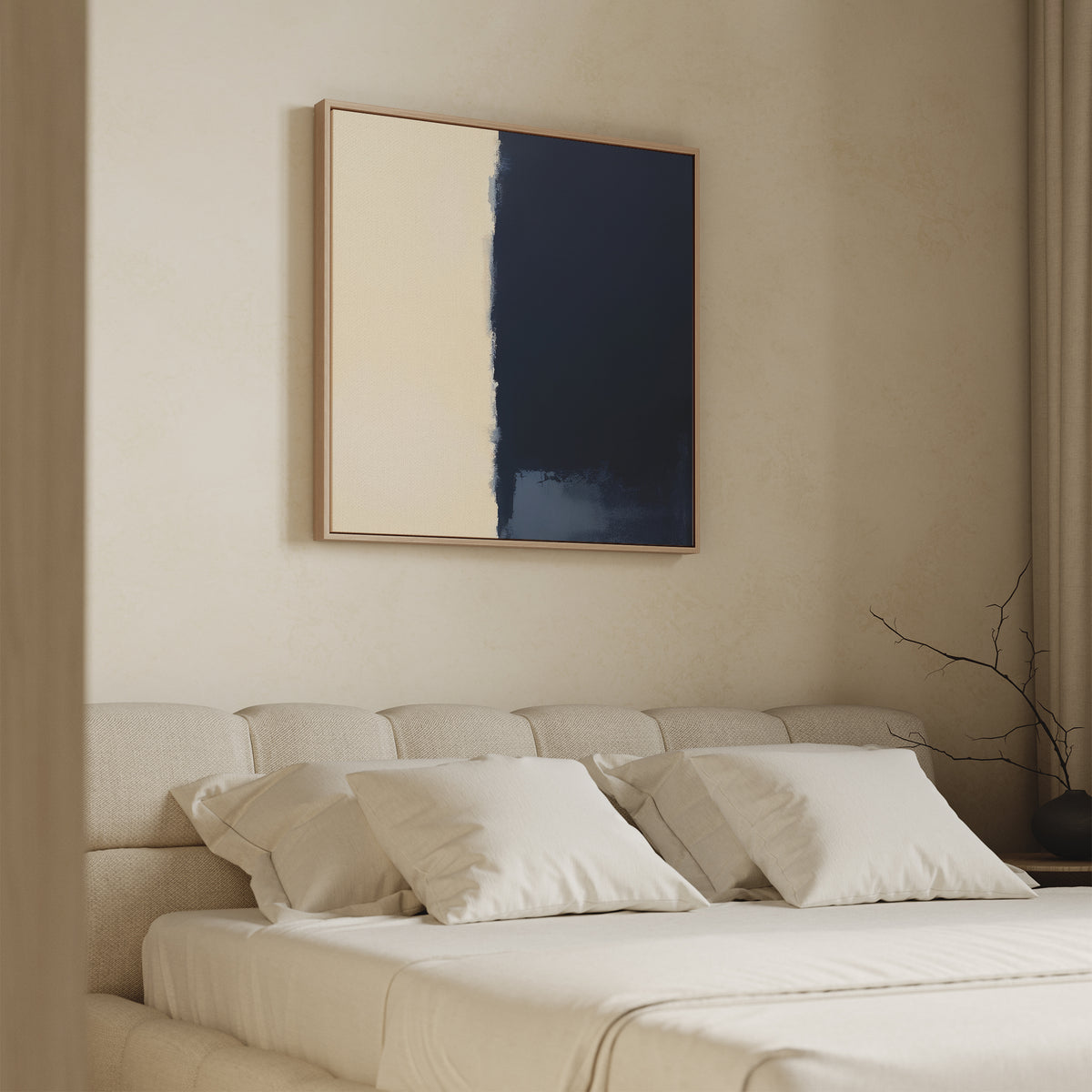 A minimal beige bedroom features a cushioned bed with four cream pillows and the Navy Division Canvas Art - Square above the headboard. A bare branch in a vase sits on the bedside table as soft light streams through curtains.