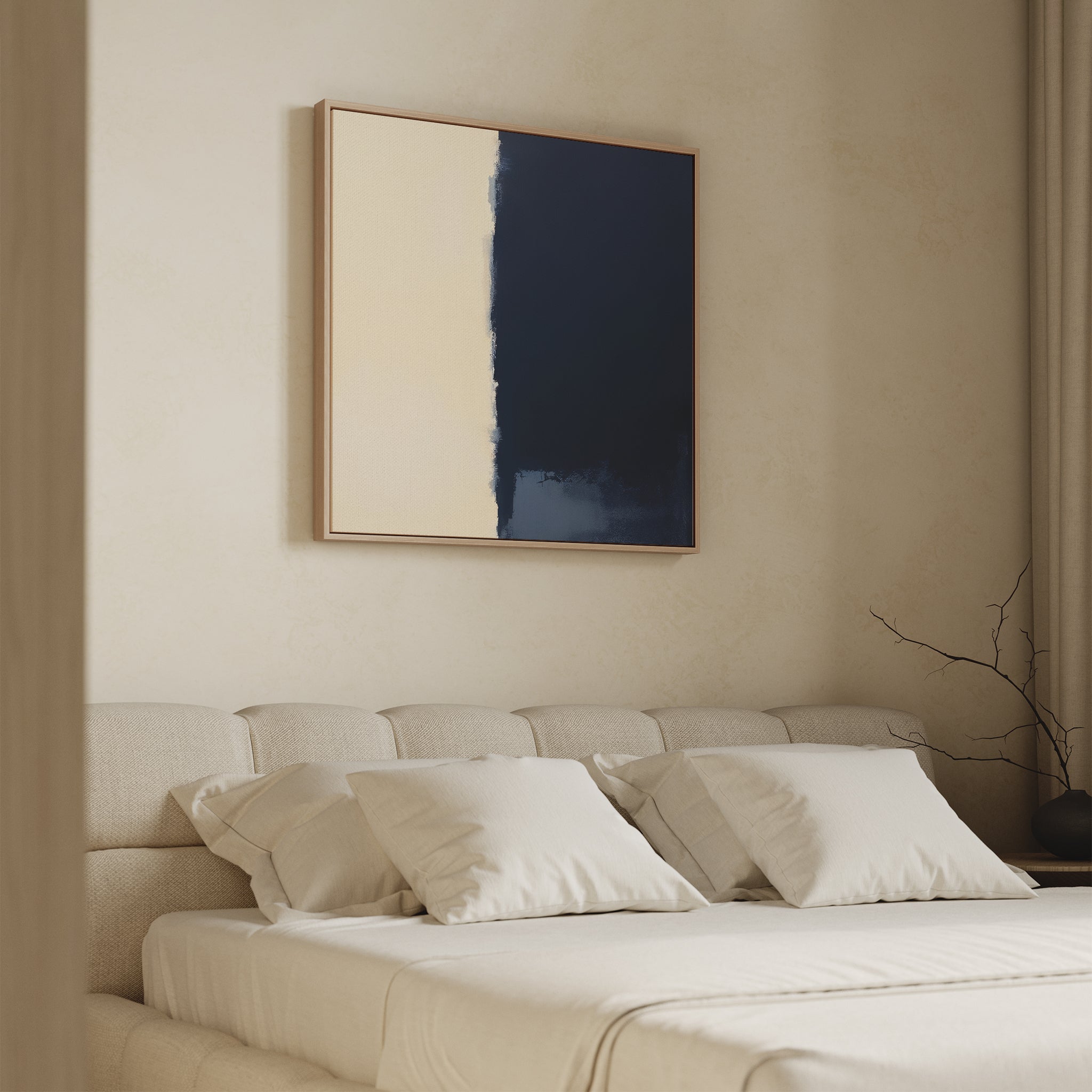 A minimal beige bedroom features a cushioned bed with four cream pillows and the Navy Division Canvas Art - Square above the headboard. A bare branch in a vase sits on the bedside table as soft light streams through curtains.