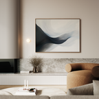 A modern living room with a brown curved sofa, a low marble shelf, minimalist decor, and the Rippling Vista Abstract Canvas Art featuring flowing blue and white shapes above the shelf for a touch of modern elegance.