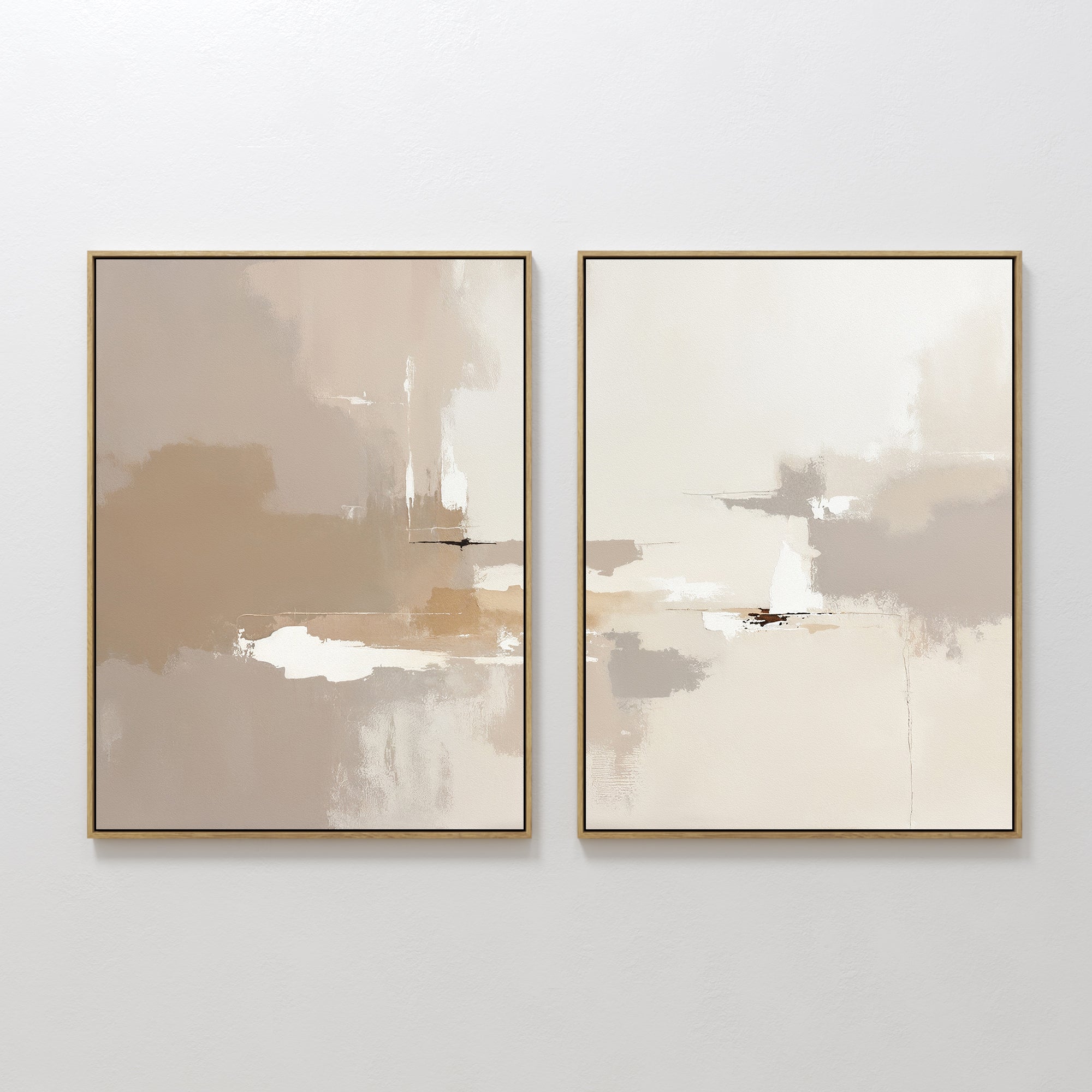 Neutral Territory - Set Of 2 features minimalist abstract prints in beige, tan, white, and light brown tones with gold frames. These artworks add soft, contemporary elegance to any white wall.