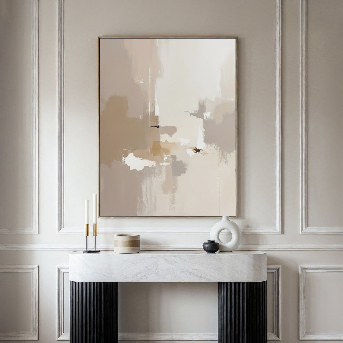 The Neutral Territory Canvas Art - Vertical, a modern abstract print in neutral tones, hangs on a paneled wall above a white marble console table with minimalist vases and candles—ideal for contemporary living rooms.